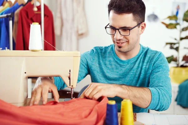 Designer working on sewing machine