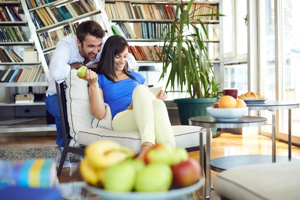 Couple at home websurfing on internet