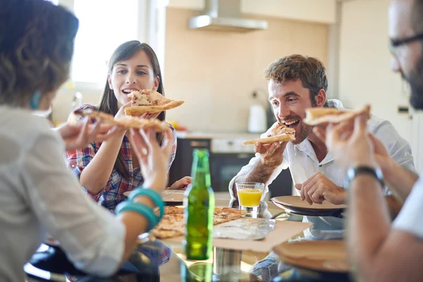 Two couples eating pizza
