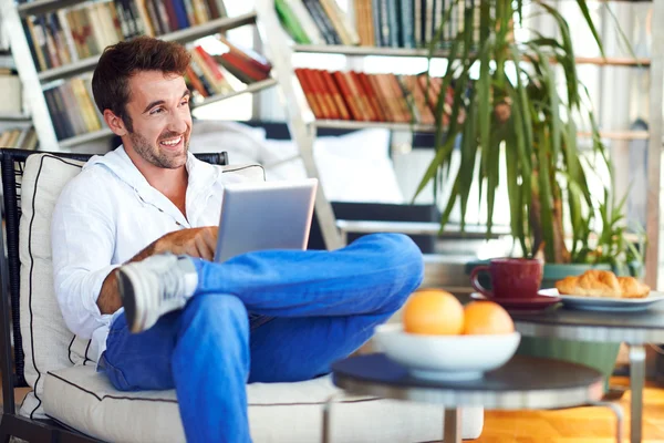 Man relaxing with digital tablet