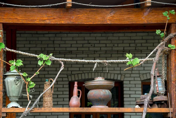 Old  subjects on terrace of house with vine grapes