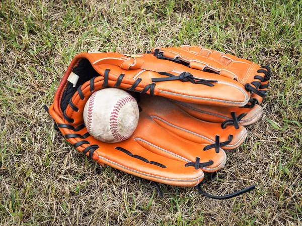 Nostalgic baseball in glove on a baseball field