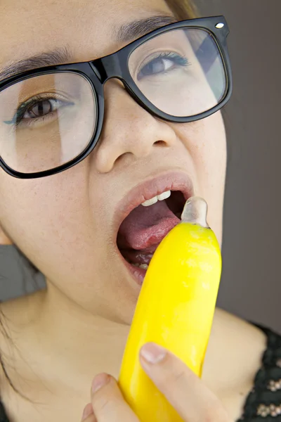 Beautiful woman with black sunglasses sexy eating banana