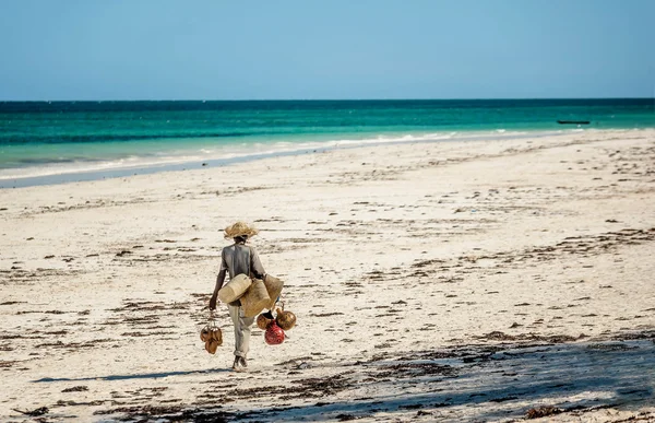African Man selling souvenirs on the beach in Kenya, Africa