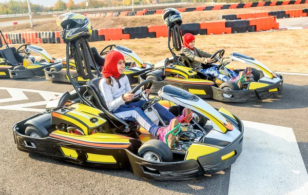 Little girls preparing to drive  Go- Kart car in a playground