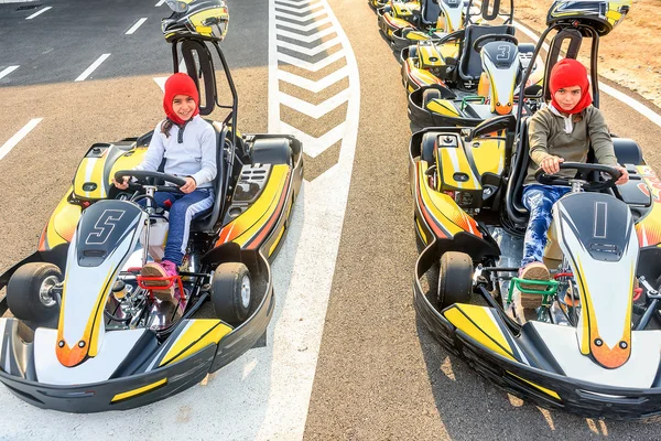 Little girls preparing to drive  Go- Kart car in a playground