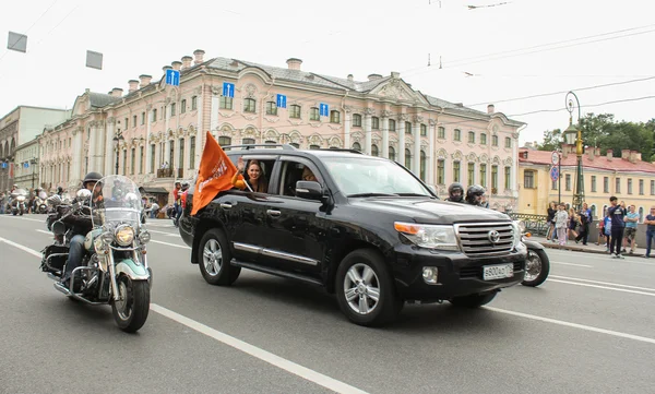 The SUV with the flag of the sponsoring company.