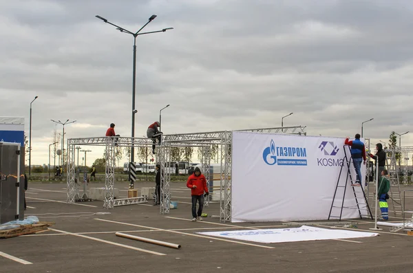 Workers assemble metal structures