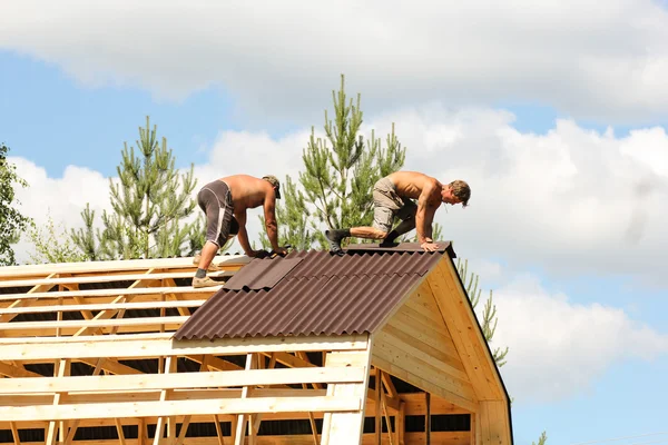 Workers working on the roof ridge.