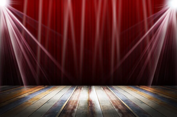 Light in dark room with colorful wooden floor and red stage wall