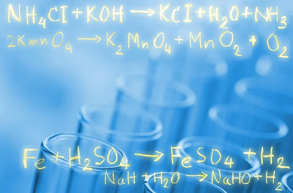 Laboratory test tubes with gold chemical equation background