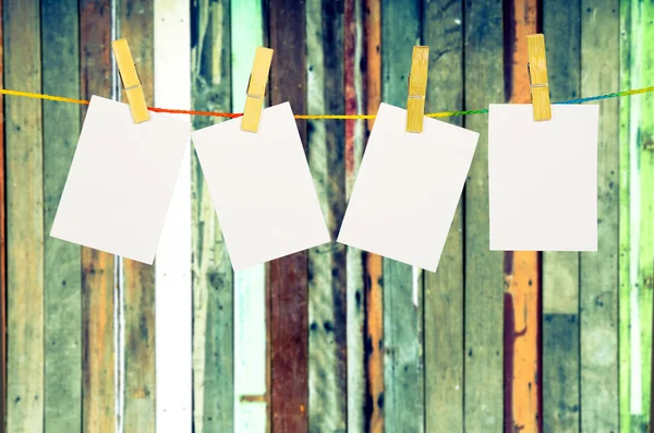 Empty white photographs hanging on a clothesline isolated on whi