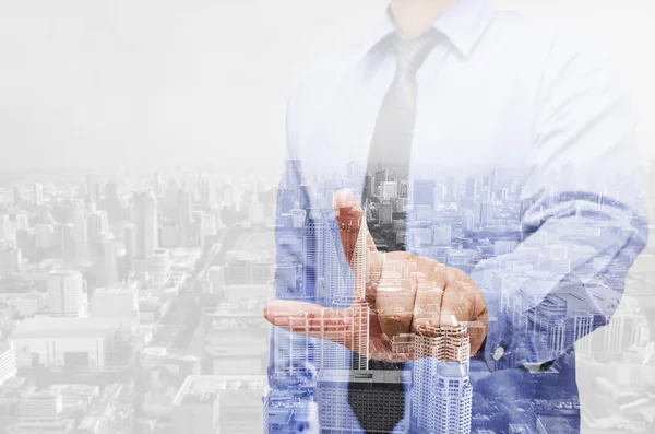 Double exposure of business man with modern building background
