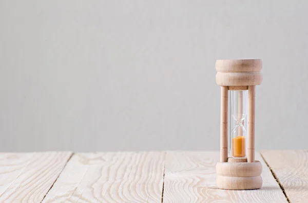 Sandglass on the wooden table