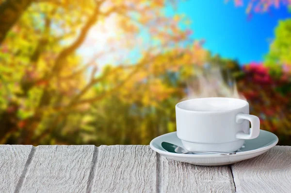White coffee cup with beautiful natural background