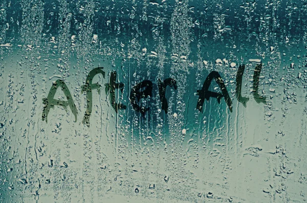 Natural water drops on glass window with the text \