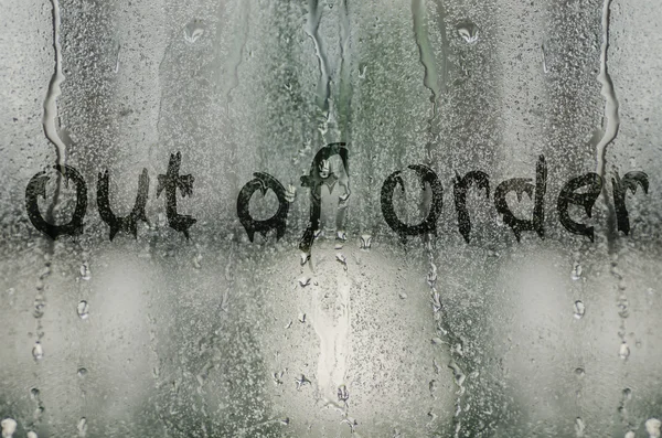 Natural water drops on glass window with the text \