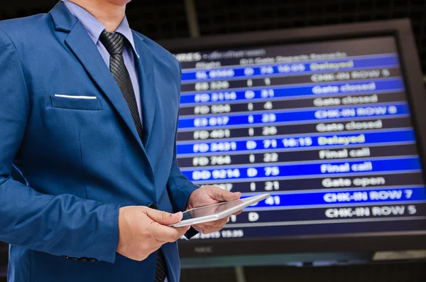 Business man holding tablet in hand with bill board background