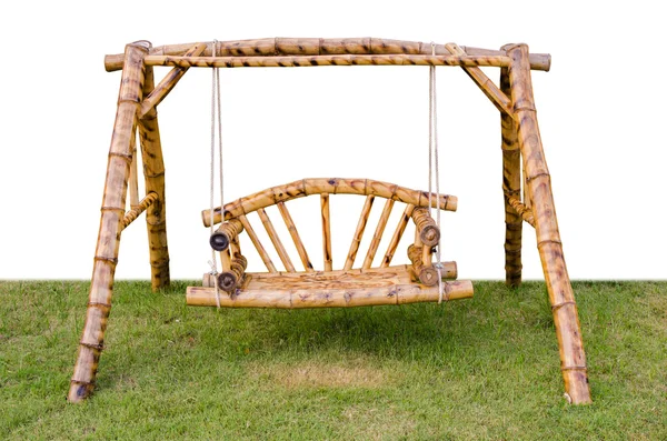 Brown wood swing chair on green grass