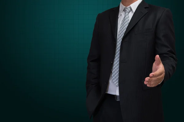 Business man with welcome hand in black suite on green backgroun