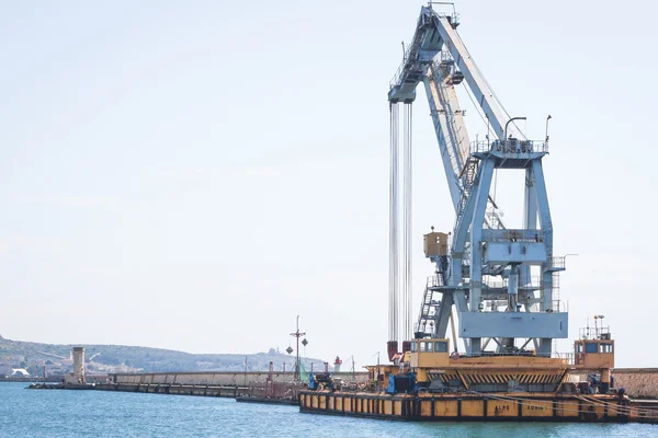 Old crane at the dock of the port