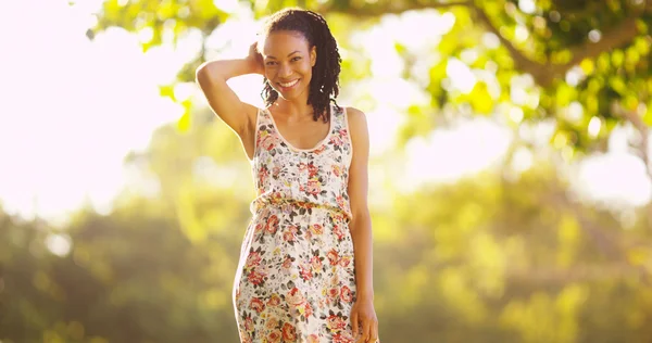 Happy black woman standing on grass