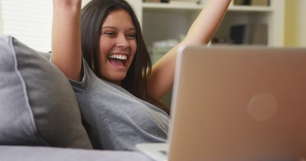 Mixed race woman excited and happy about her team winning