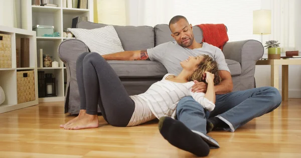 Black couple sitting on floor talking