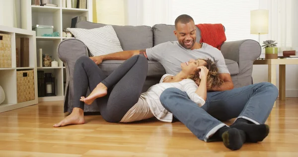 Black couple sitting on floor talking