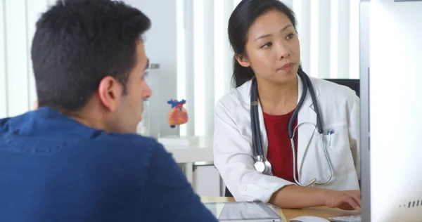 Chinese doctor explaining xray to patient