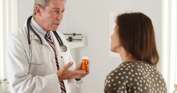 Doctor explaining prescription to elderly woman patient