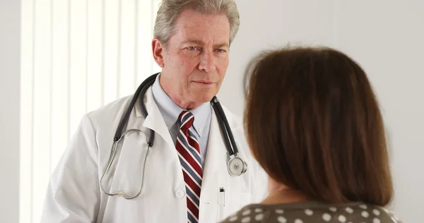 Senior doctor having a conversation with patient