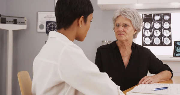 Black female radiologist discussing with mature female