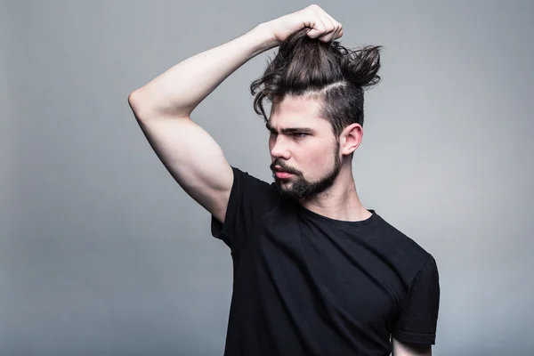Young man in  black T-shirt with fashionable hairstyle