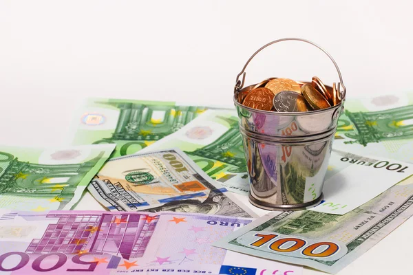 Euro banknotes, dollars and bucket with Russian money