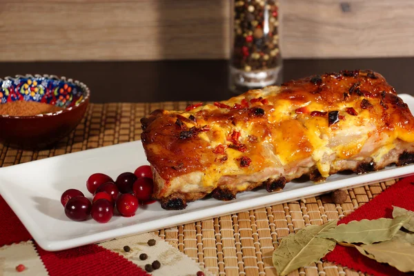 Pork ribs, baked with mustard sauce with cranberries