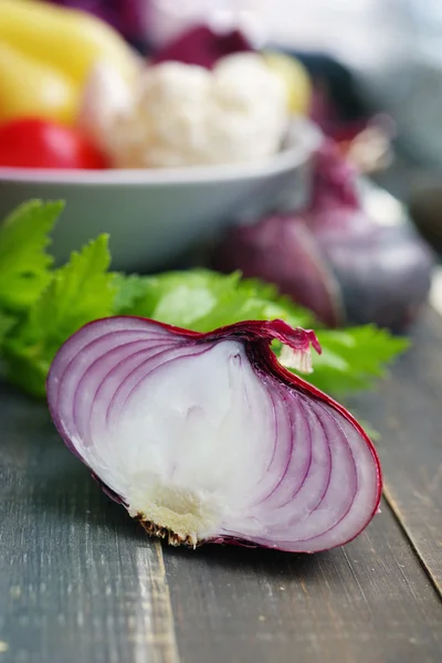 Red onions on a wooden table. Fresh  vegetables on wooden background table from above.