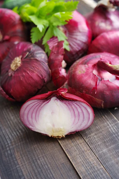 Red onions on a wooden table. Fresh  vegetables on wooden background table from above.