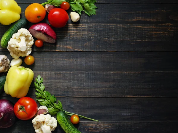 Fresh  vegetables on wooden background table from above.