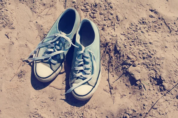 Blue sports gym shoes on sand