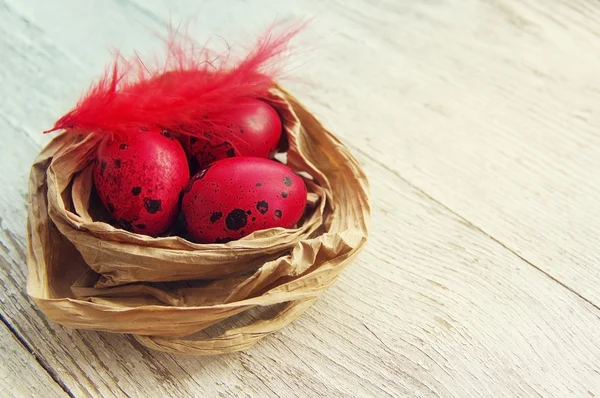 Happy Easter red eggs in a decorative nest.