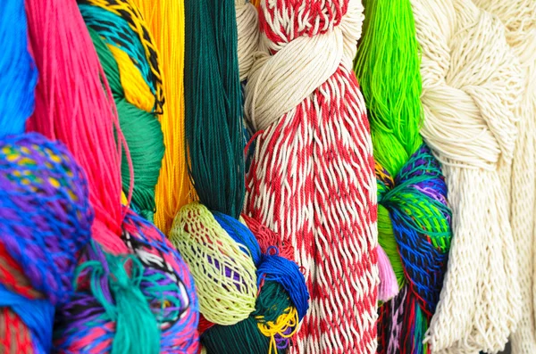 Closeup of colorful hammoks hanging knotted at the craft market