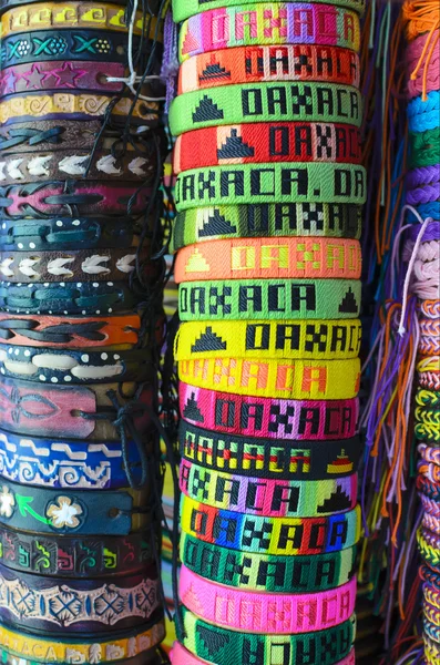 Numerous colorful wristbands with Oaxaca sight for sale at craft market