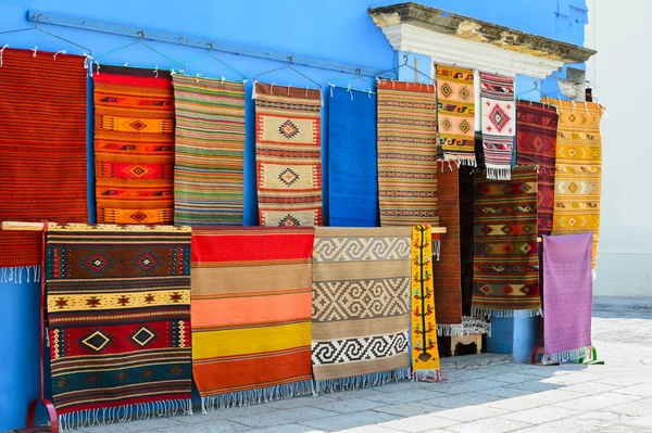 Wall of a local store with traditional Mexican handmade carpets on display
