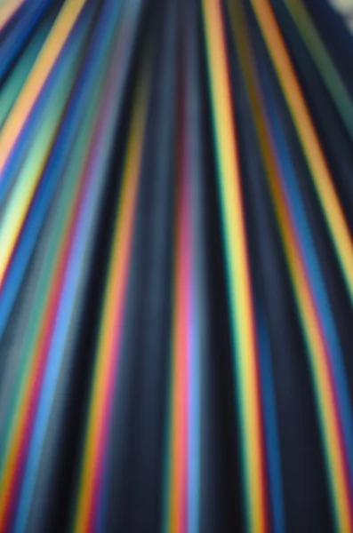 Colorful rainbow stripes on black in warm tone