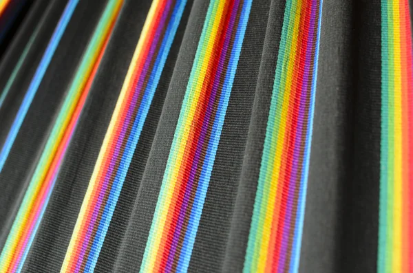 Rainbow colored stripes on black fabric