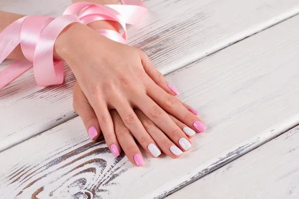 Manicure with pink ribbon.