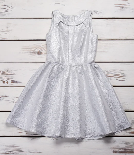 Silver dress with scoop neckline.