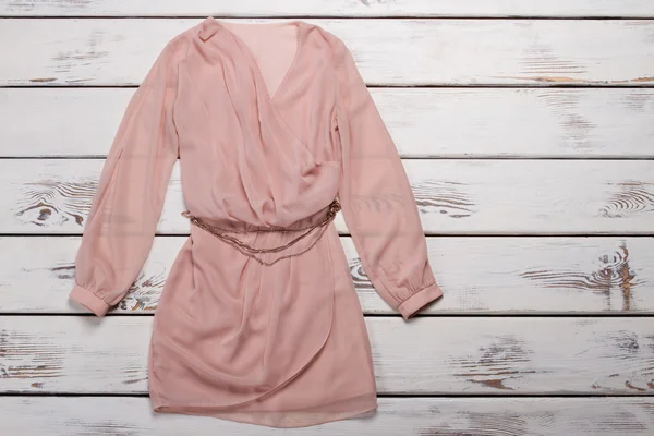 Peach dress with long sleeves.