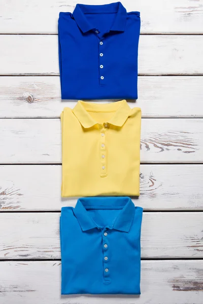 Blue, navy and yellow t-shirts.